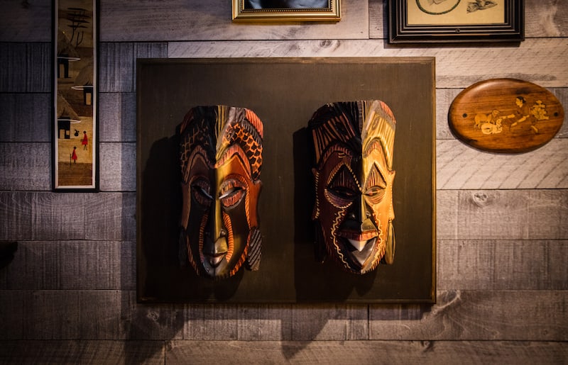 In-game: A wall mounting with two tribal masks hanging.