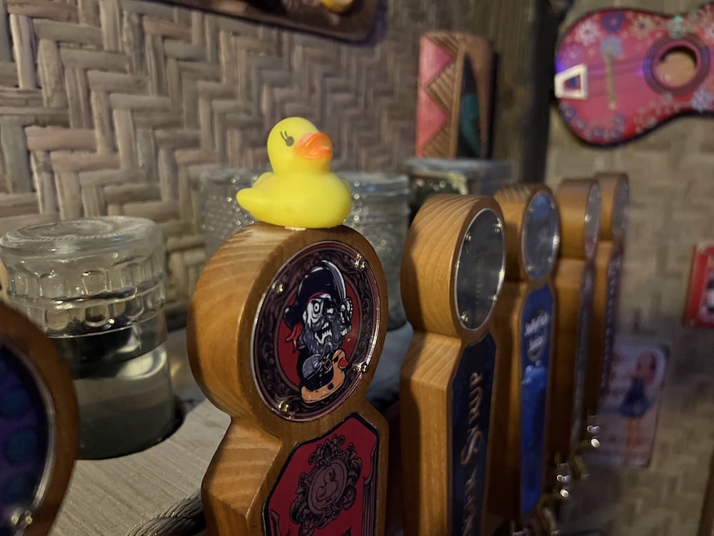 A little rubber ducky atop a beer tap.