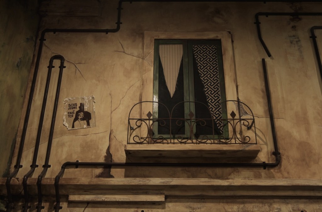 The exterior window of an old apartment.
