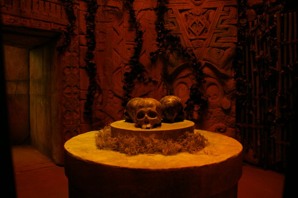 In-game: three skulls resting on a pedestal inside of Mayan ruins.