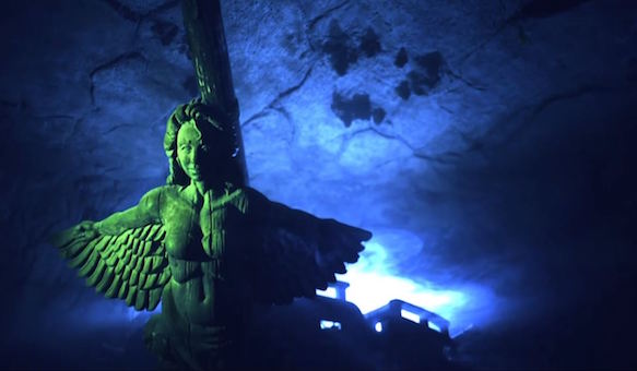 In-game: The carved wooden figurehead of a winged woman on the bow of bow of an old ship.