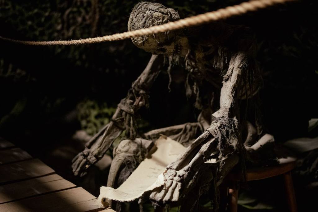 A dead and long decayed body holding a letter.