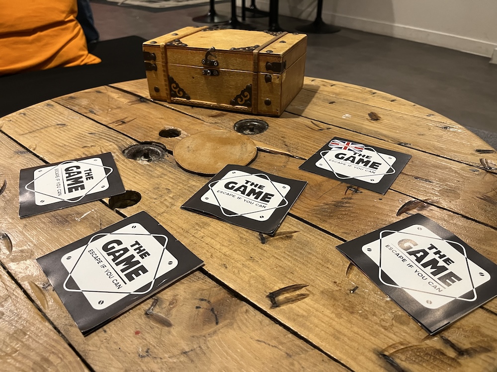 A collection of booklets on a tabletop, they each say, "The Game," one says "English."