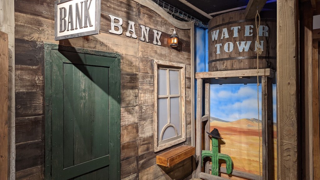An old western bank beside a water tower.