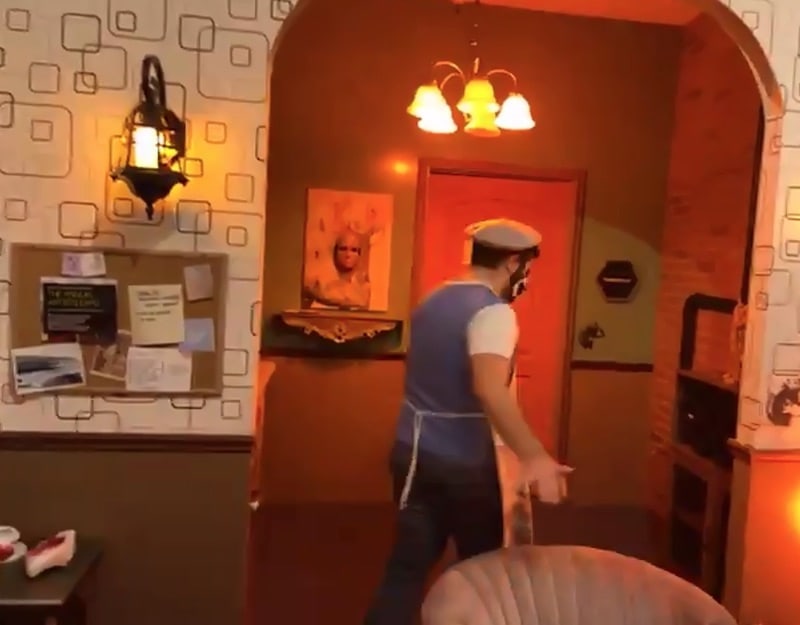 The artist walking around in his home.