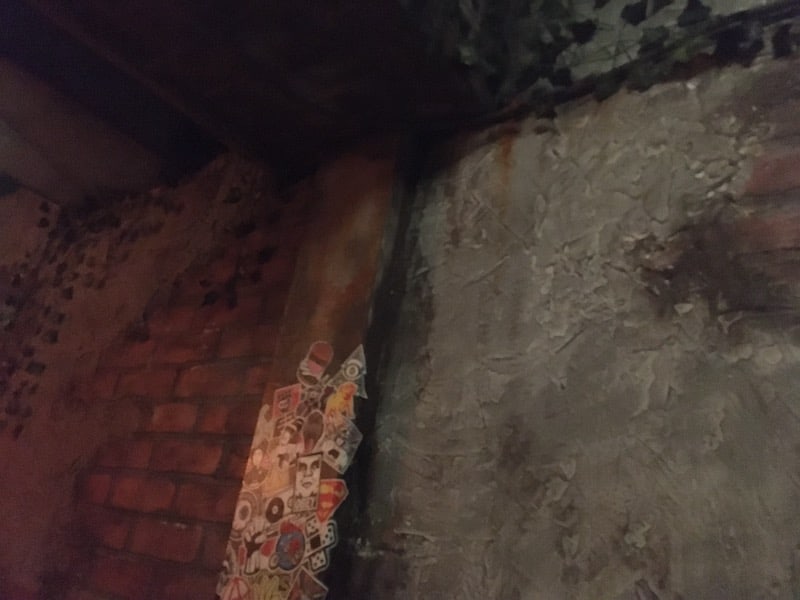 In-game: A detailed, heavily worn brick, concrete, and steel wall.