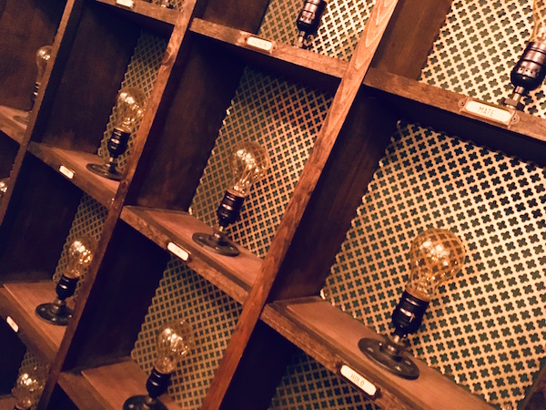 In-game: a grid of incandescent light bulbs all labeled with different words.