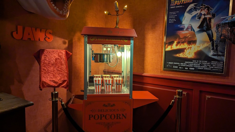 A popcorn machine besides posters and displays for Back To The Future and JAWS.