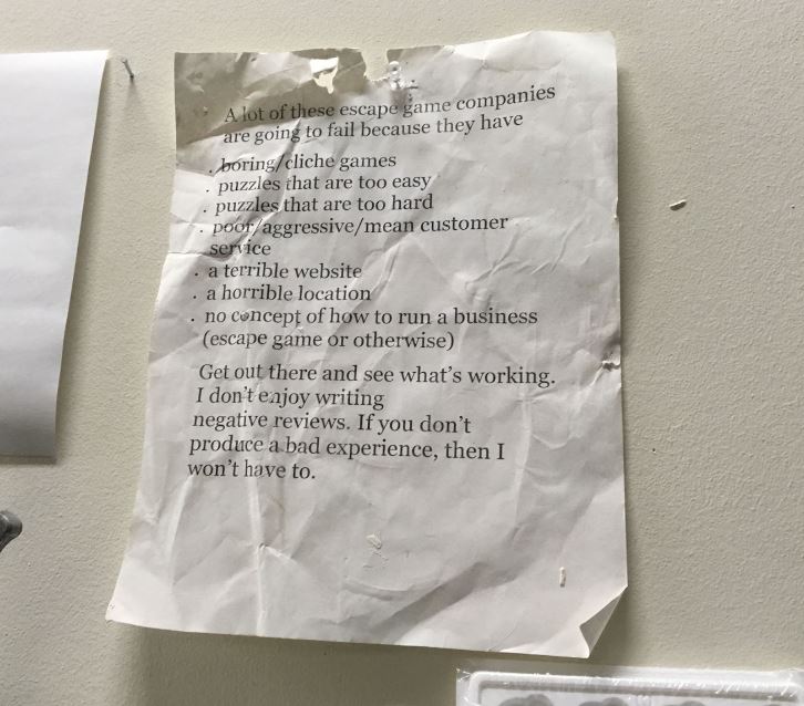 paper pinned to wall with excerpt of a REA Post about why companies fail.
