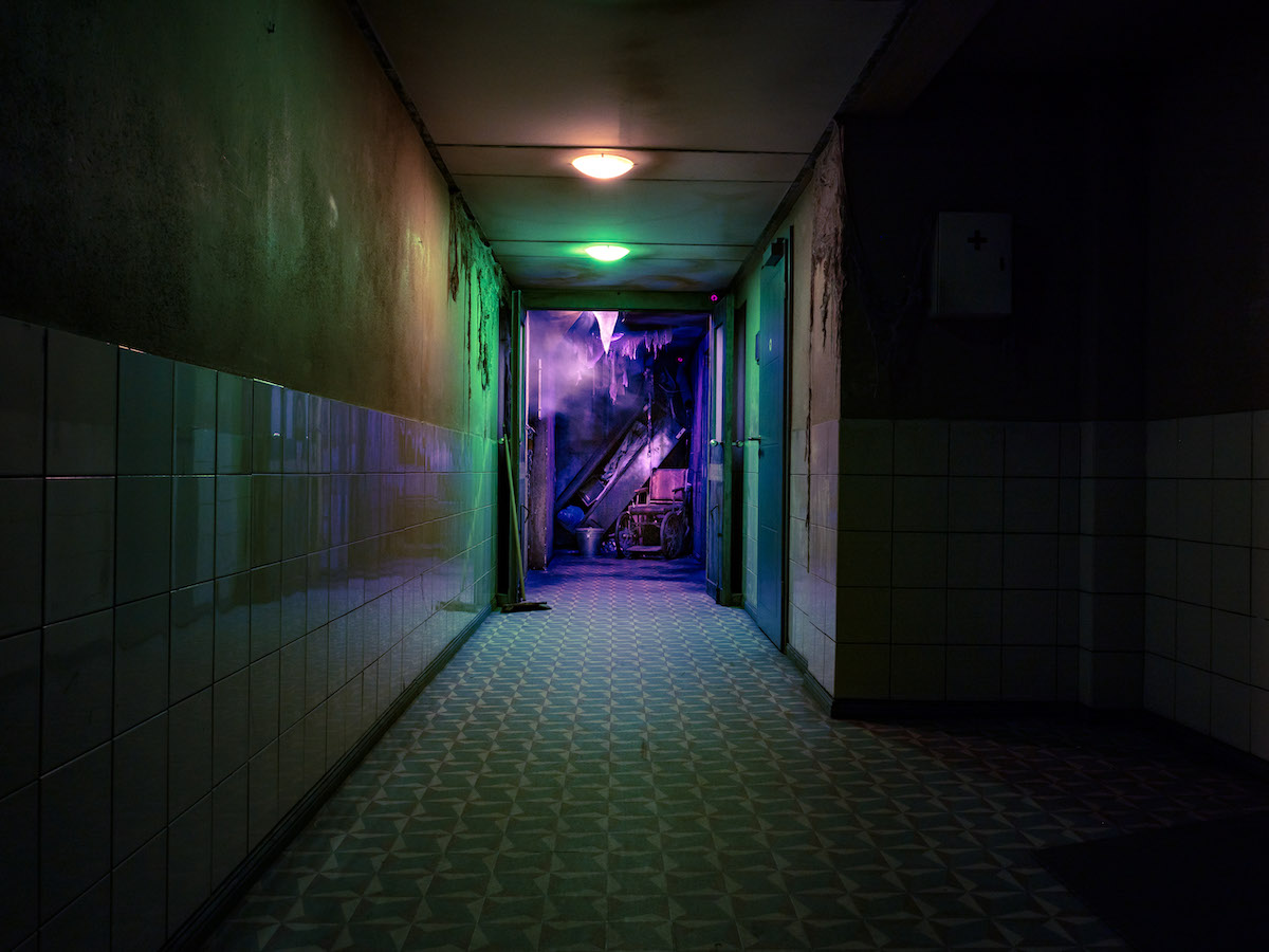 View down a hallways in a rundown and abandoned hospital.