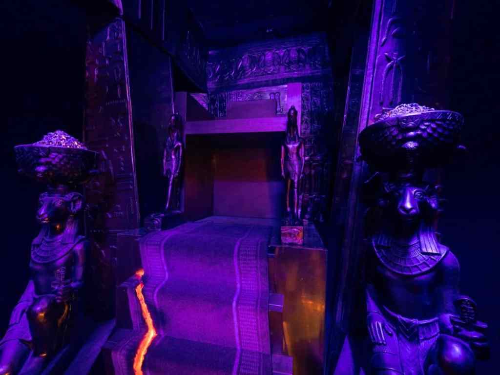 stairs in what appears to be an Egyptian temple with statues of leopard headed gods