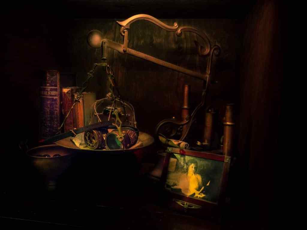 antique scale with a pair of steampunk binoculars, books and a photo frame