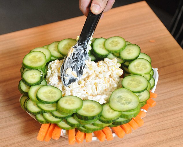 building base of salad tower. concentric rings of cucumber filled with macaroni salad