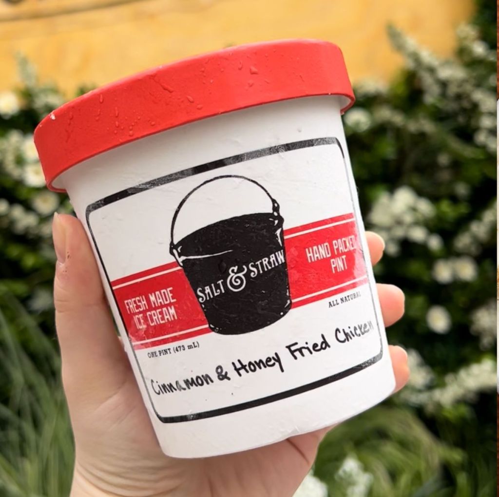 hand holding a pint of ice cream from Salt & Straw in the flavor Cinnamon & Honey Fried Chicken