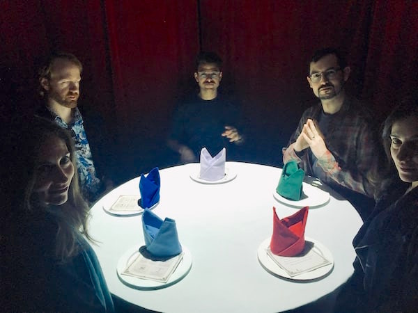 In-game: Team B surrounding their white table.