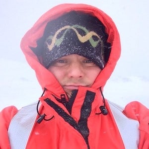 Steve Ewing in a bright orange jacket in Antarctica