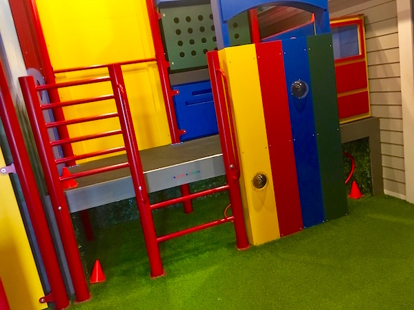 In-game: a bright and colorful jungle gym on green turf.