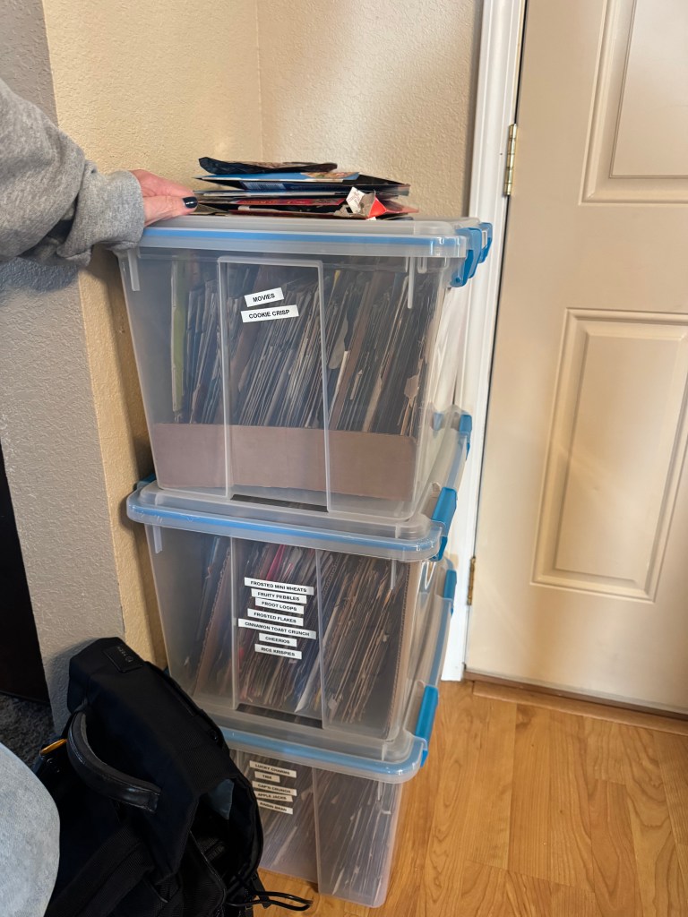 plastic clear bins stacked, filled with cardboard