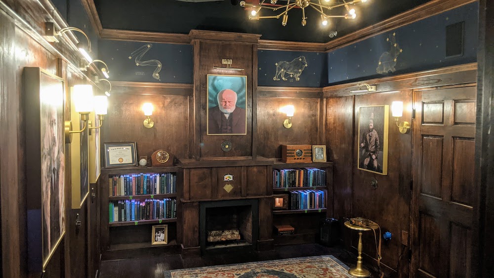 An elegant old study with zodiac symbols painted on the walls.