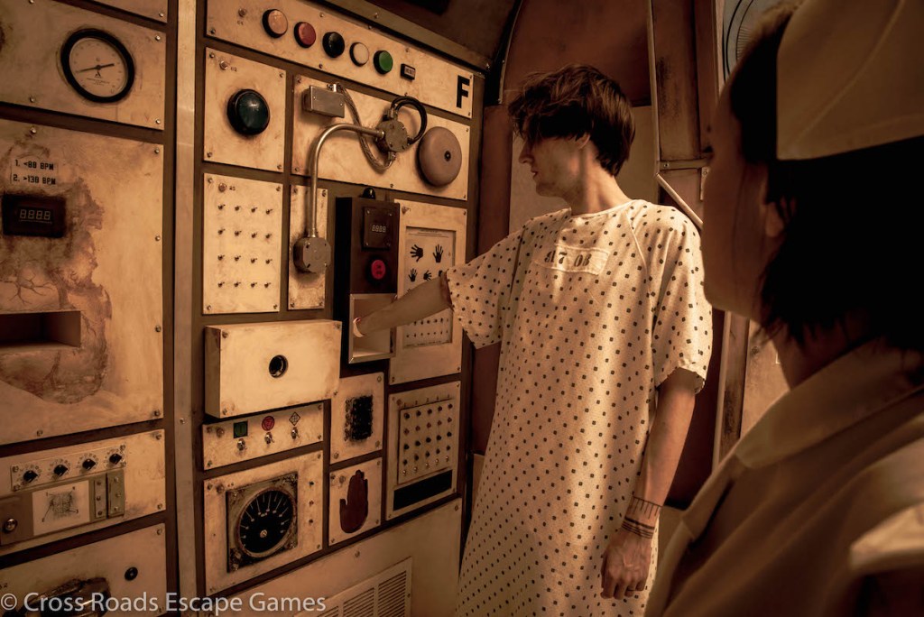 A patient sticking their harm into a hole in a machine.