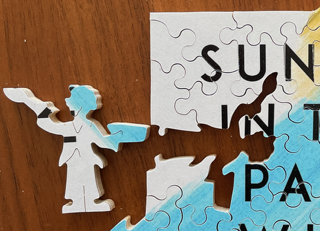 wooden jigsaw puzzle from sunday in the park with george with cutout shaped like a person
