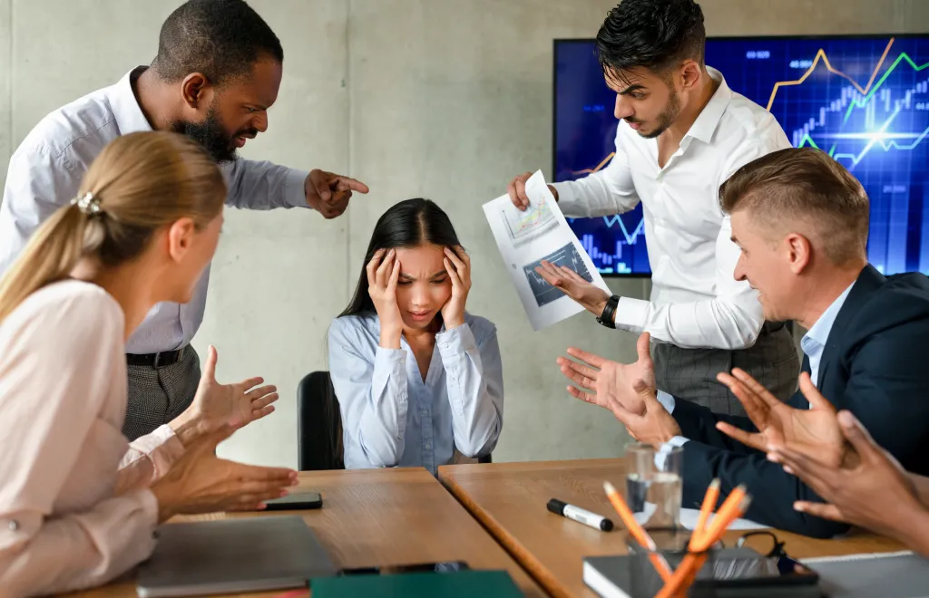 4 people bullying a woman of their team